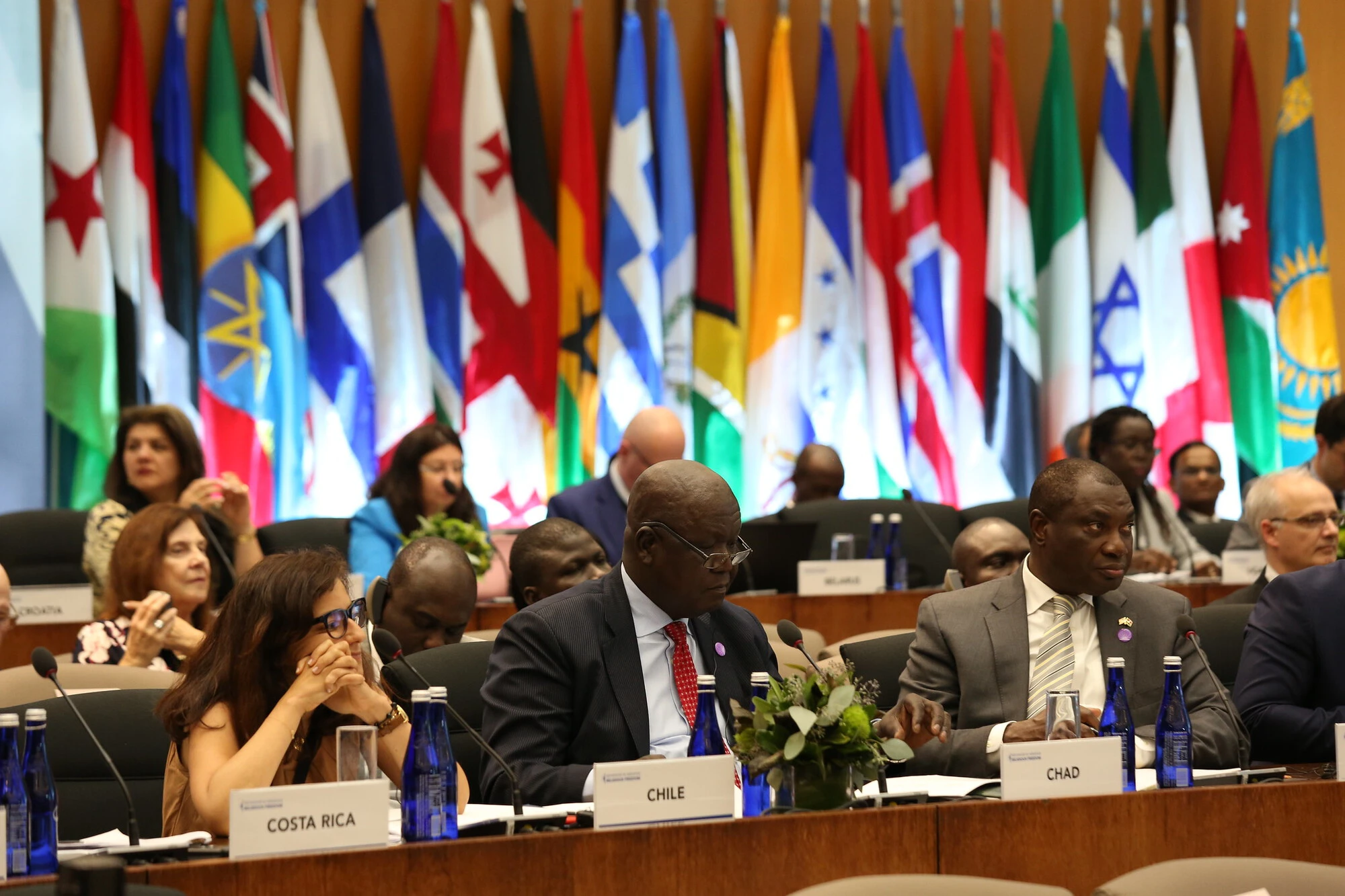 Delegates from diverse religious backgrounds engaging in dialogue at a United Nations conference, symbolizing global efforts for interfaith harmony and cooperation.