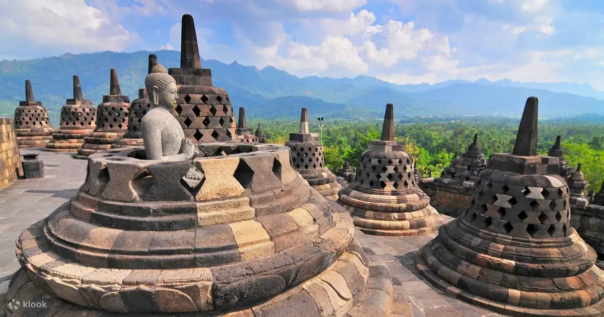 Dawn breaking over Borobudur Temple, highlighting the intricate relief panels and stupas against a serene backdrop.