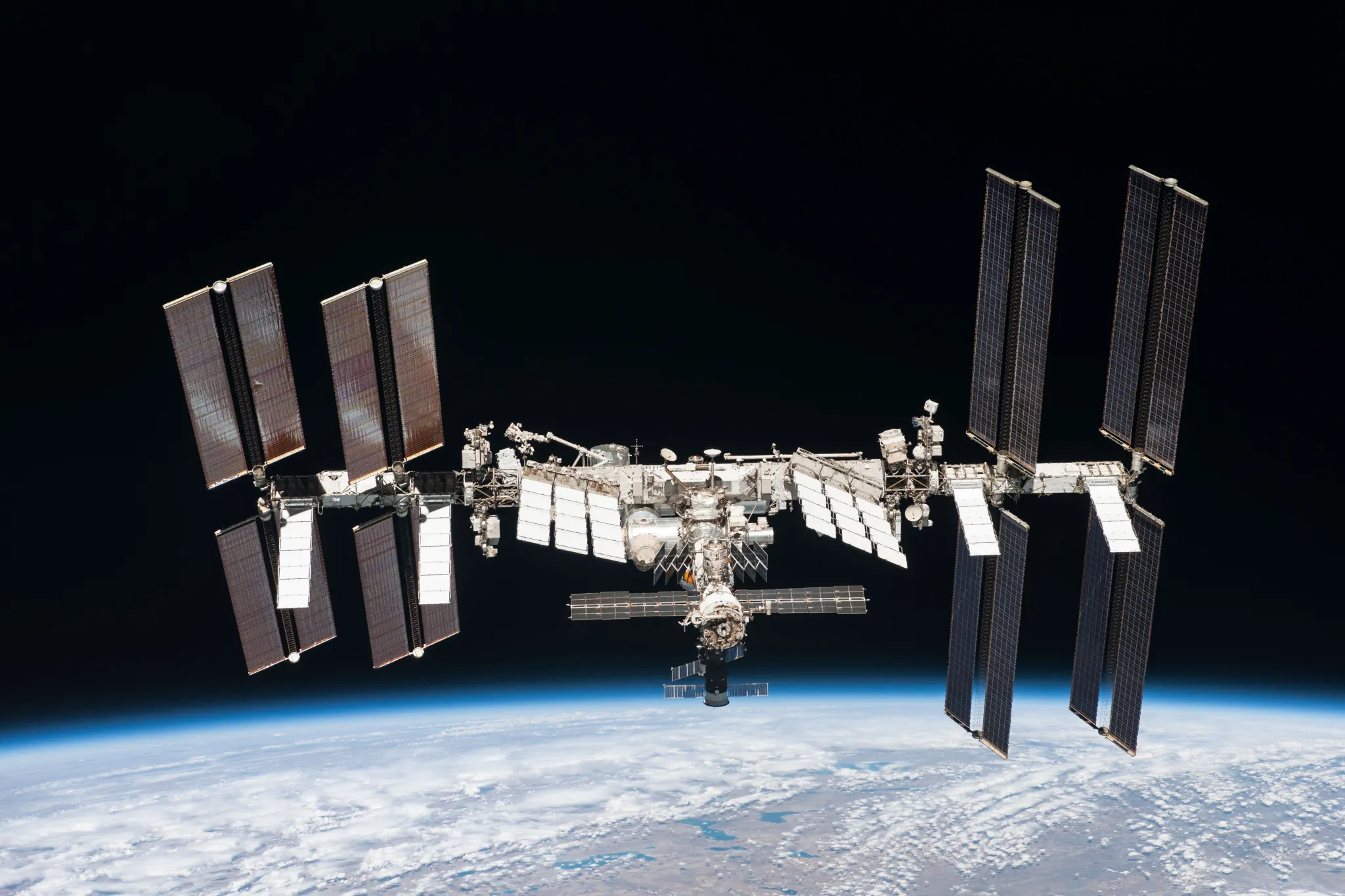 The International Space Station orbits Earth, a testament to human ingenuity and a symbol of international partnership in space exploration.